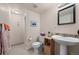 Full bathroom featuring wood vanity, toilet and tiled shower with beach themed decor at 7888 Canvasback Cir, Littleton, CO 80125