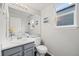 Well-lit half bathroom with a gray vanity, white countertop, and neutral-toned walls at 7888 Canvasback Cir, Littleton, CO 80125