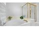 Bright bathroom featuring a soaking tub and glass-enclosed shower with gold trim at 7888 Canvasback Cir, Littleton, CO 80125