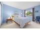 Comfortable bedroom features soft blue walls, a large window and furnishings at 7888 Canvasback Cir, Littleton, CO 80125