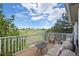 Relaxing outdoor deck area with seating and tables, offering scenic views of the pond and nature at 7888 Canvasback Cir, Littleton, CO 80125