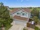 Aerial view of a two-story home, mature landscaping, and views of a pond, and the surrounding neighborhood at 7888 Canvasback Cir, Littleton, CO 80125