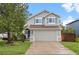 Charming two-story home with a well-manicured lawn, gray siding, and a two-car garage at 7888 Canvasback Cir, Littleton, CO 80125