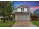 Charming two-story home with a well-manicured lawn, gray siding, and a two-car garage at 7888 Canvasback Cir, Littleton, CO 80125