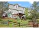 Two-story home features a backyard with a deck, patio, swing set, fire pit, and landscaped yard at 7888 Canvasback Cir, Littleton, CO 80125