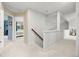 Bright upstairs hallway with carpeted floors and access to rooms with natural light at 7888 Canvasback Cir, Littleton, CO 80125