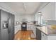 Modern kitchen featuring stainless steel appliances, including a refrigerator, microwave, dishwasher and gas range with ample cabinet space at 7888 Canvasback Cir, Littleton, CO 80125