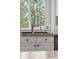 Close up of the kitchen sink featuring neutral color countertop and cabinets with a window overlooking greenery at 7888 Canvasback Cir, Littleton, CO 80125