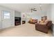 Cozy living room with a ceiling fan, a fireplace, and comfortable seating arrangements at 7888 Canvasback Cir, Littleton, CO 80125