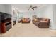 Spacious living room with a fireplace, a ceiling fan, and comfortable seating arrangements at 7888 Canvasback Cir, Littleton, CO 80125
