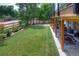 Green backyard featuring manicured lawn, landscaping, and a covered patio at 8140 S Storm King Peak, Littleton, CO 80127
