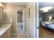 En-suite bathroom with tiled floor, single vanity with a modern faucet, with a view of the main bedroom at 8140 S Storm King Peak, Littleton, CO 80127
