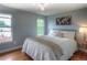 Serene bedroom featuring bright windows, hardwood floors, and calming blue walls at 8140 S Storm King Peak, Littleton, CO 80127