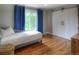 Bright bedroom with hard wood flooring, sliding closet doors and a cozy daybed for relaxation at 8140 S Storm King Peak, Littleton, CO 80127