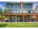 Rear exterior view of a two-story home with a deck and covered patio at 8140 S Storm King Peak, Littleton, CO 80127