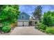 Charming two-story home with a well-manicured lawn, mature trees, and a double-car garage at 8140 S Storm King Peak, Littleton, CO 80127