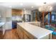 Stylish kitchen featuring modern appliances, a large island, and wood and white cabinets at 8140 S Storm King Peak, Littleton, CO 80127