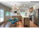 Modern kitchen features a large island, stainless steel appliances, and a cozy breakfast nook at 8140 S Storm King Peak, Littleton, CO 80127