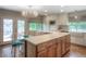 Bright kitchen with an island, stainless steel appliances, and an adjacent dining area at 8140 S Storm King Peak, Littleton, CO 80127