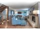 Spacious living room showcases hardwood floors, a stone fireplace, comfortable seating, and access to a spiral staircase at 8140 S Storm King Peak, Littleton, CO 80127