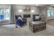 Cozy living room showcasing a modern fireplace, two comfortable armchairs, and stylish decor at 8140 S Storm King Peak, Littleton, CO 80127