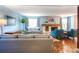 Inviting living room with hardwood floors, stone fireplace, comfortable sofas, and ample natural light from large windows at 8140 S Storm King Peak, Littleton, CO 80127
