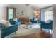 Cozy living room featuring hardwood floors, comfortable seating, and a stylish round mirror at 8140 S Storm King Peak, Littleton, CO 80127