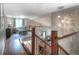 Upper staircase landing with hardwood floors, leading to the lower living area and providing an open, airy feel at 8140 S Storm King Peak, Littleton, CO 80127