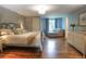 Cozy primary bedroom featuring hardwood floors, calming blue walls, and a comfortable lounge area at 8140 S Storm King Peak, Littleton, CO 80127