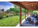 Back patio with a view of the green backyard and the wooden fence at 8140 S Storm King Peak, Littleton, CO 80127