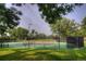Community tennis court surrounded by lush greenery, offering a recreational space for residents at 8140 S Storm King Peak, Littleton, CO 80127
