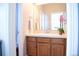 Bathroom with vanity, single sink, and wood cabinets for storage at 11883 E Fair Ave, Greenwood Village, CO 80111