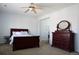 Bright bedroom features a ceiling fan and dark wood furniture set at 11883 E Fair Ave, Greenwood Village, CO 80111