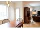 Bright dining area with a wooden table, chairs, and view into the living room at 11883 E Fair Ave, Greenwood Village, CO 80111