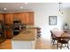 Well-equipped kitchen with granite countertops, stainless steel appliances, and an adjacent dining area at 11883 E Fair Ave, Greenwood Village, CO 80111