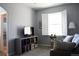 Living room features a bright window with shutters and a built-in bookcase at 11883 E Fair Ave, Greenwood Village, CO 80111