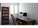 Home office area with built-in desk, shutters, and a bookcase for storage at 11883 E Fair Ave, Greenwood Village, CO 80111
