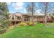 Expansive backyard featuring a spacious deck, lush green lawn, and mature landscaping, perfect for outdoor living at 6093 Willowbrook Dr, Morrison, CO 80465
