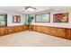 Cozy basement featuring paneled walls, plush carpeting, bright natural light, and serene outdoor views at 6093 Willowbrook Dr, Morrison, CO 80465