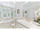 Bright bathroom featuring a soaking tub with natural light and a marble vanity at 6093 Willowbrook Dr, Morrison, CO 80465