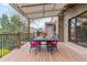 Covered deck with outdoor dining and serene views, ideal for enjoying meals and gatherings at 6093 Willowbrook Dr, Morrison, CO 80465