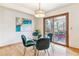 Cozy dining area featuring glass table, seating for four and a sliding glass door to outdoor deck at 6093 Willowbrook Dr, Morrison, CO 80465