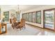 Traditional dining room boasts ample natural light and mountain views, with seating for six and a decorative chandelier at 6093 Willowbrook Dr, Morrison, CO 80465