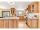Bright kitchen with custom wood cabinets, central island, stainless appliances, and wood flooring creates a warm, inviting space at 6093 Willowbrook Dr, Morrison, CO 80465