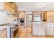 Well-appointed kitchen with stainless steel appliances, custom cabinetry, stone countertops and eat-in kitchen island at 6093 Willowbrook Dr, Morrison, CO 80465