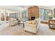 Bright and airy living room with a stone fireplace, large windows, and comfortable seating, perfect for relaxing or entertaining guests at 6093 Willowbrook Dr, Morrison, CO 80465