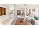 Open-concept living room with tile floors, a staircase, and plenty of natural light, creating a warm and inviting atmosphere at 6093 Willowbrook Dr, Morrison, CO 80465