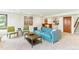 Stylish living room showcasing a tufted sofa, unique art, and soft carpeting enhancing the inviting space at 6093 Willowbrook Dr, Morrison, CO 80465