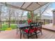 Covered patio includes a dining table with mountain views, creating an ideal outdoor living space for relaxation and entertaining at 6093 Willowbrook Dr, Morrison, CO 80465