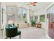 Bright sunroom with large windows, comfortable seating, and a ceiling fan at 6093 Willowbrook Dr, Morrison, CO 80465